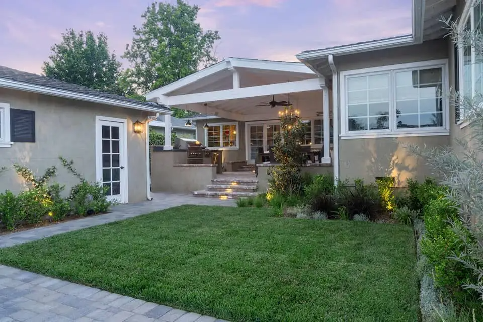 Covered timber deck with a built-in outdoor kitchen and dining area